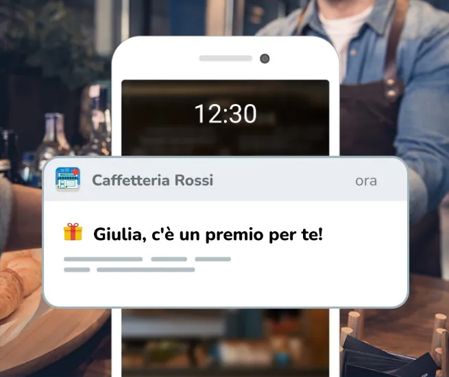 Un telefono al bancone riceve una notifica da Caffetteria Rossi: «Giulia, c’è un premio per te»